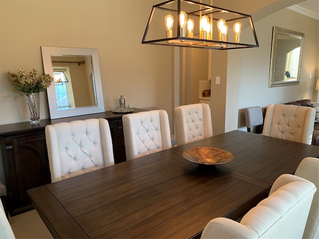 dining room featuring crown molding