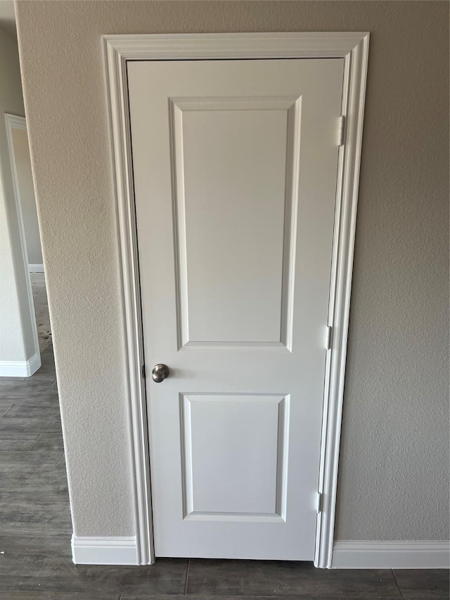268 Sunnyside Dr, Trenton, TX 75490 - detailed view of baseboards, wood finished floors, and a textured wall