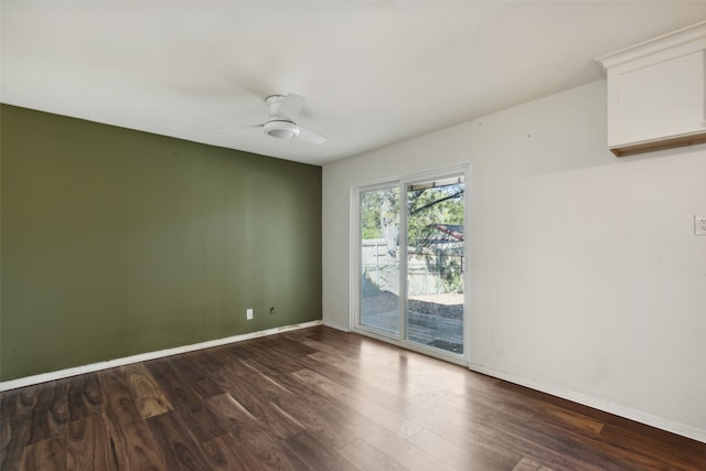 spare room featuring dark hardwood / wood-style floors and ceiling fan