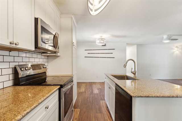 kitchen with white cabinetry, stainless steel appliances, sink, and dark hardwood / wood-style flooring