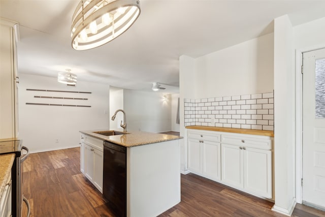 kitchen with sink, dishwasher, dark hardwood / wood-style flooring, hanging light fixtures, and white cabinetry