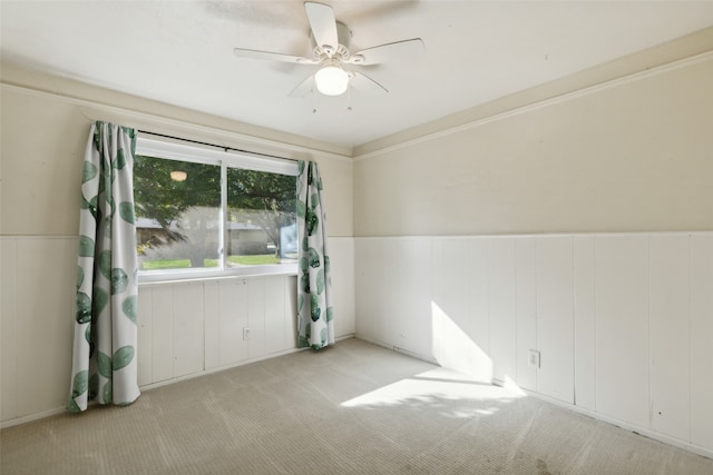 carpeted spare room with ceiling fan