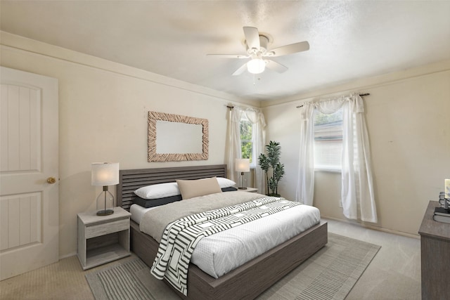 carpeted bedroom with crown molding and ceiling fan