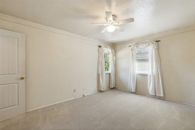 empty room with light carpet and ceiling fan