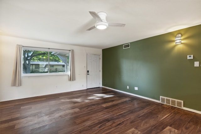 unfurnished room featuring dark hardwood / wood-style floors and ceiling fan