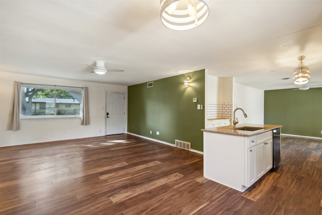 kitchen featuring decorative backsplash, white cabinetry, dishwasher, dark hardwood / wood-style floors, and sink