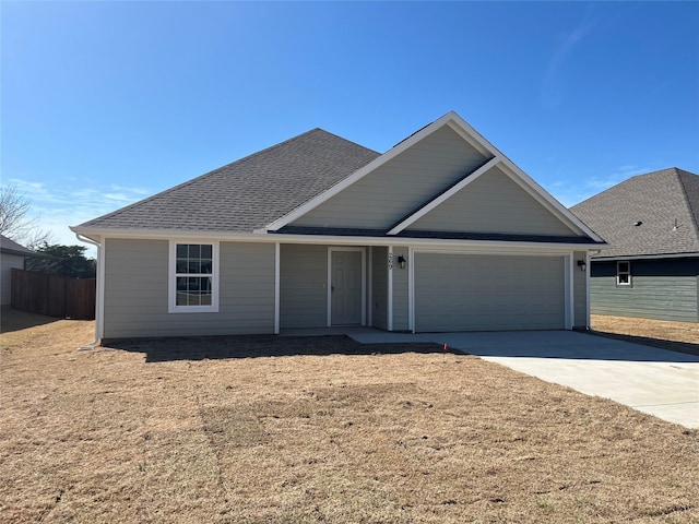 single story home featuring fence, concrete driveway, an attached garage, and a shingled roof