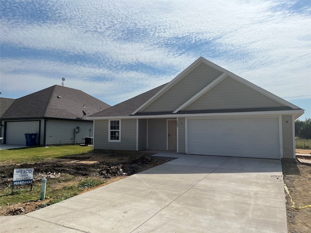 ranch-style house with cooling unit and a garage