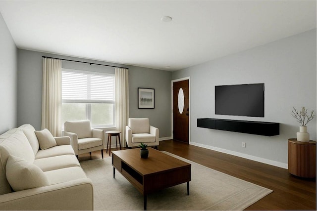 living area with wood finished floors and baseboards