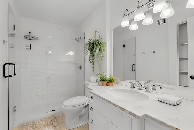 full bathroom with a shower stall, toilet, and vanity