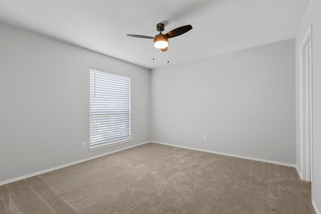 empty room featuring baseboards, ceiling fan, and carpet floors