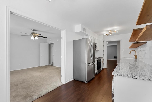 kitchen with ceiling fan, a sink, white cabinetry, dark wood-type flooring, and stainless steel appliances
