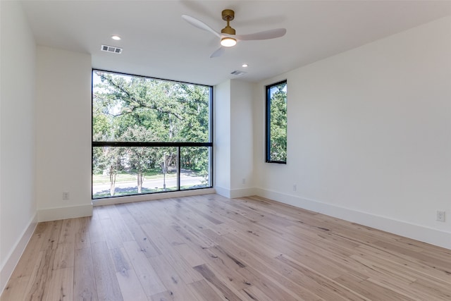 bathroom featuring a shower with door, vanity, hardwood / wood-style flooring, and a skylight