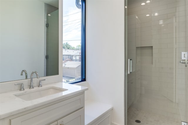 bathroom featuring vanity and a shower with shower door