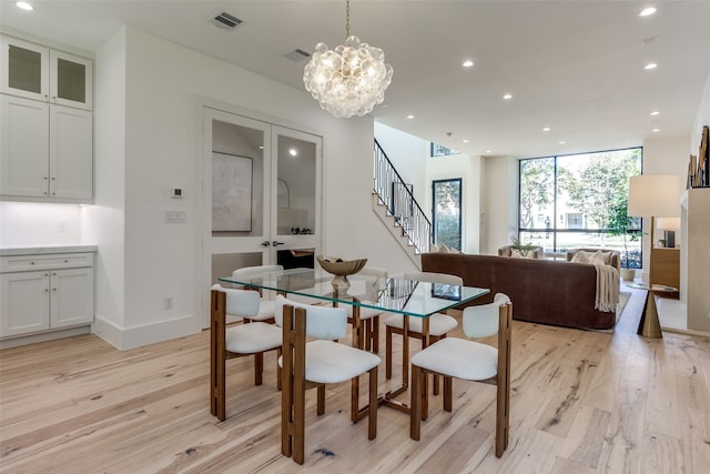 kitchen featuring light hardwood / wood-style flooring, white cabinets, stainless steel appliances, and an island with sink