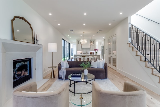 kitchen featuring sink, appliances with stainless steel finishes, white cabinetry, and an island with sink