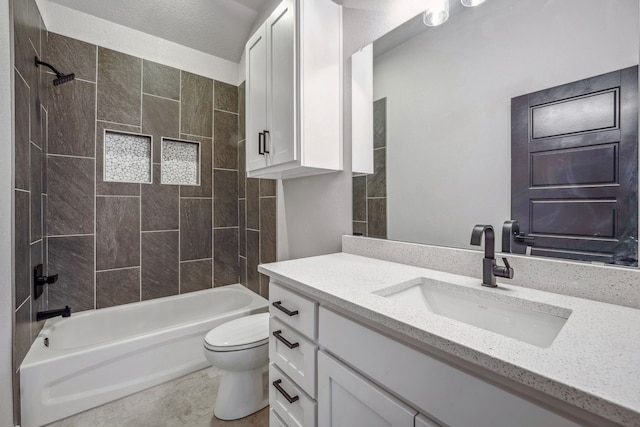 full bathroom featuring toilet, tiled shower / bath combo, and vanity