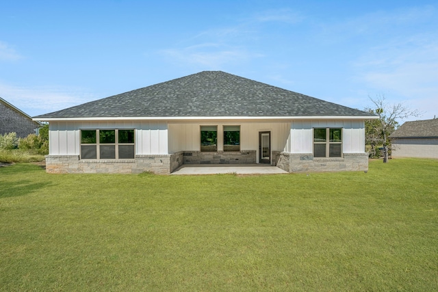 back of property featuring a yard and a patio