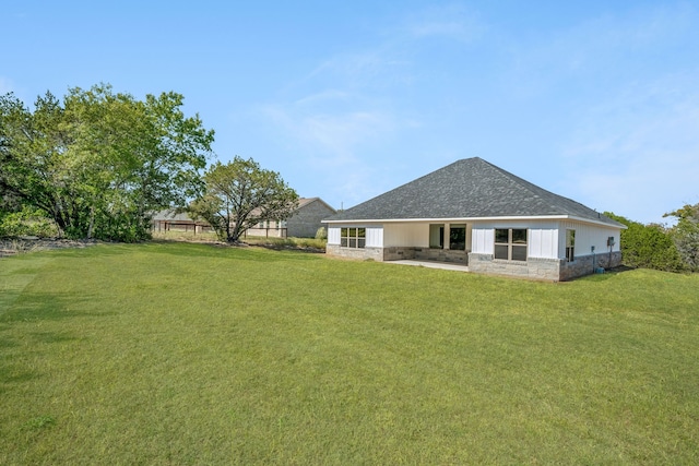 rear view of house with a yard