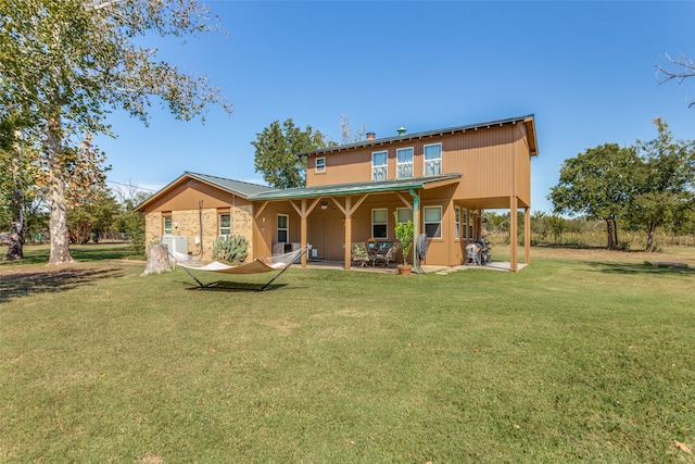 rear view of property featuring a yard