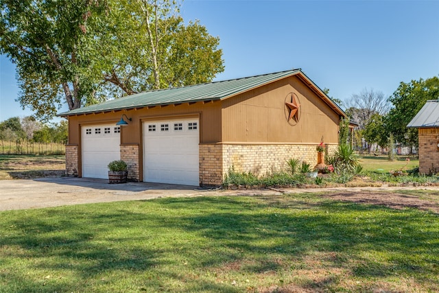 view of home's exterior featuring an outdoor structure, a garage, and a lawn