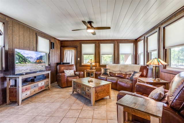 living room with wood ceiling, wooden walls, plenty of natural light, and light tile patterned floors