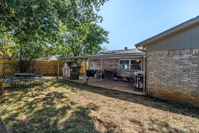 view of yard with a patio and a shed