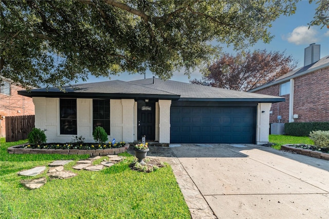 ranch-style home with a front yard and a garage