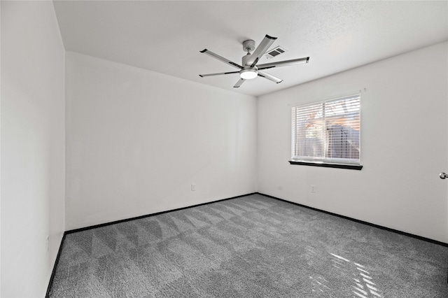 empty room with carpet flooring and a textured ceiling