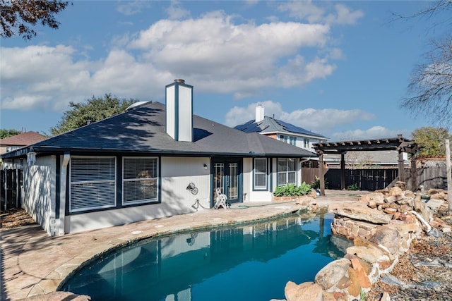 back of property featuring a pergola, a fenced in pool, and a patio