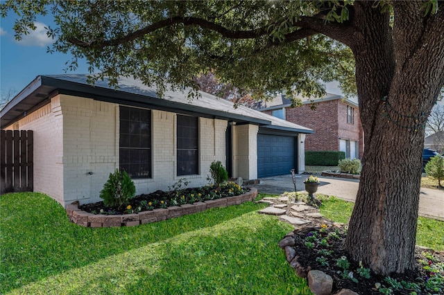 ranch-style house with a garage and a front lawn