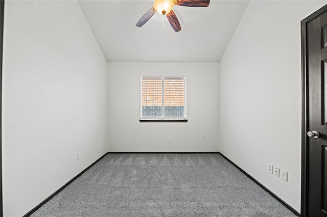 spare room featuring light carpet, ceiling fan, and lofted ceiling