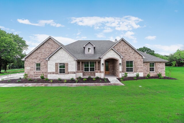 2201 Crystal Palace Blvd, Alvarado, TX 76009 - view of front facade with brick siding, a shingled roof, stone siding, and a front yard