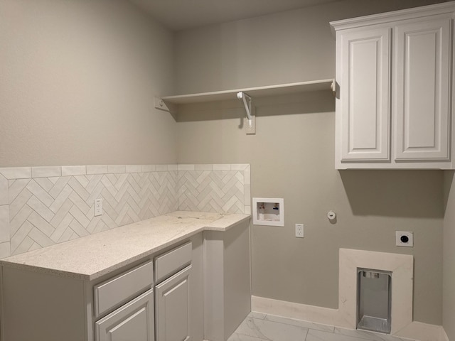 washroom featuring cabinets, hookup for a washing machine, hookup for an electric dryer, and hookup for a gas dryer