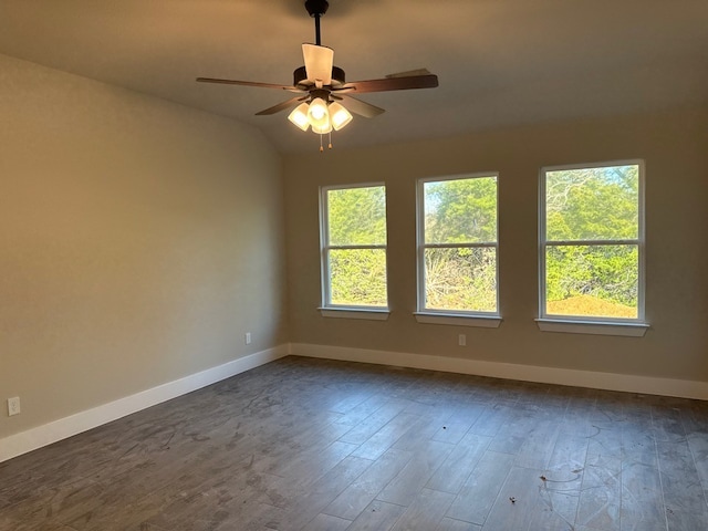 empty room with dark hardwood / wood-style flooring, ceiling fan, lofted ceiling, and a healthy amount of sunlight