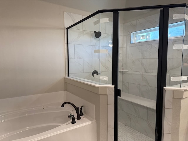 bathroom featuring separate shower and tub