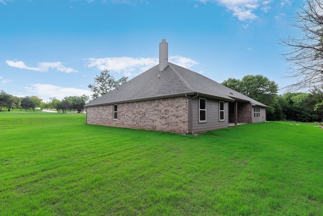 2201 Crystal Palace Blvd, Alvarado, TX 76009 - back of house featuring roof with shingles, a chimney, brick siding, and a lawn