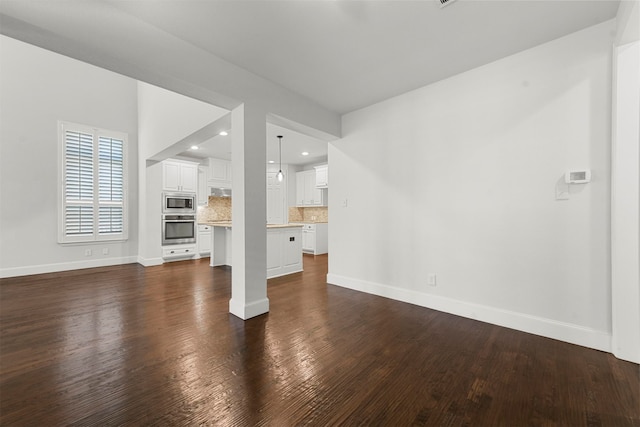 unfurnished living room with dark hardwood / wood-style floors