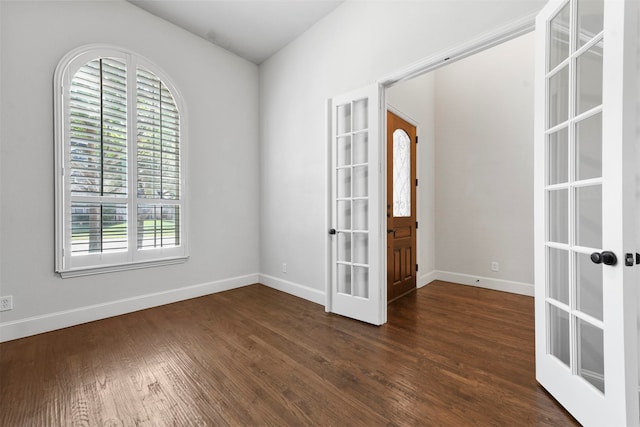 unfurnished room with french doors and dark hardwood / wood-style flooring