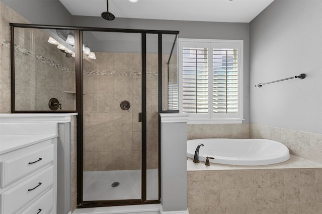 bathroom with vanity and independent shower and bath