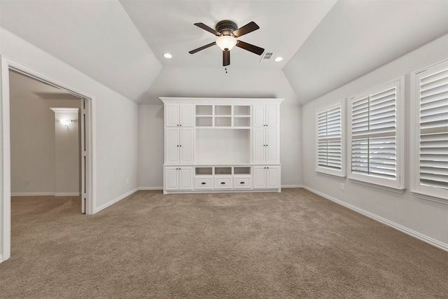 unfurnished bedroom with ceiling fan, lofted ceiling, and carpet floors