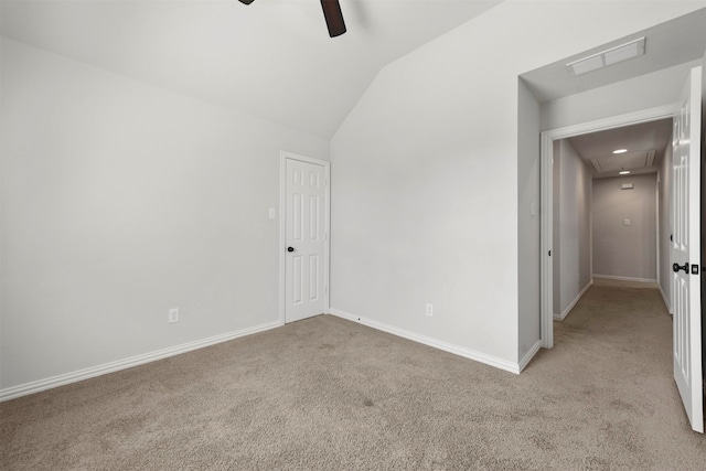 interior space with vaulted ceiling, light carpet, and ceiling fan