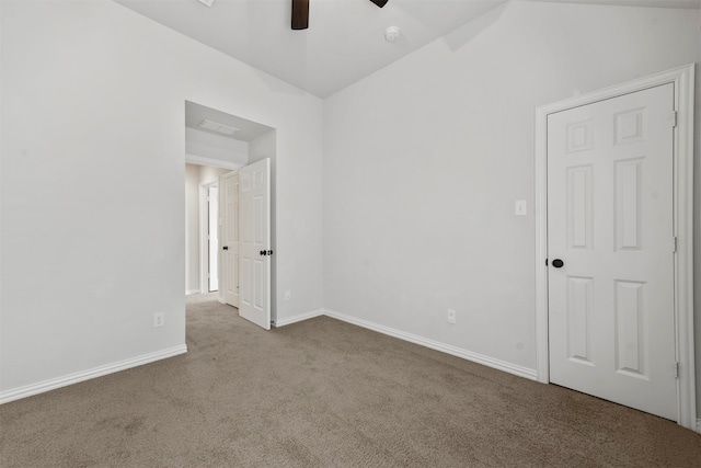 unfurnished room with ceiling fan, vaulted ceiling, and light colored carpet