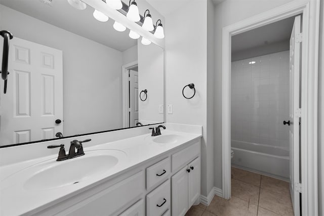 bathroom featuring vanity, tiled shower / bath, and tile patterned flooring