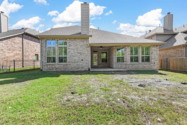 back of house featuring a yard and a patio area