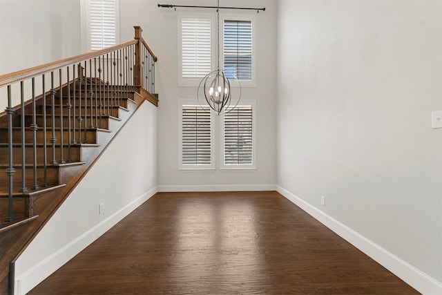 interior space with a chandelier and dark hardwood / wood-style floors