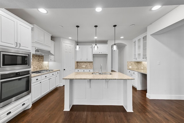 kitchen featuring white cabinetry, light stone countertops, and appliances with stainless steel finishes