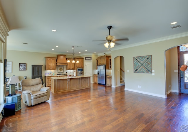 living room with dark wood-type flooring, ceiling fan, ornamental molding, and sink