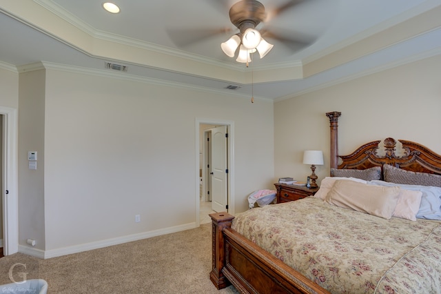 carpeted bedroom with crown molding, a tray ceiling, and ceiling fan