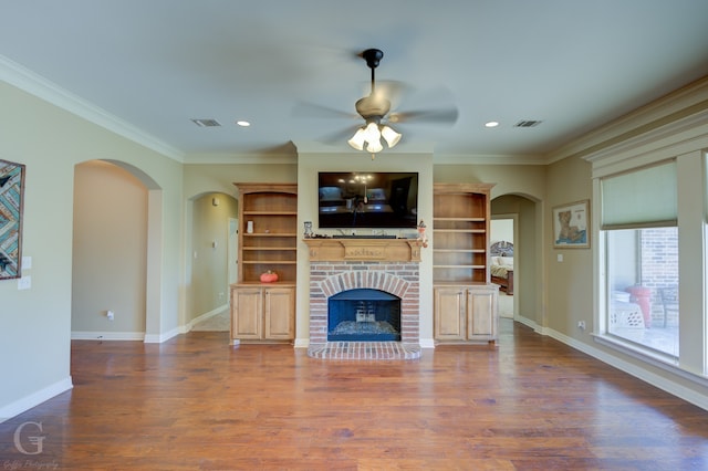 unfurnished living room featuring ornamental molding, a fireplace, hardwood / wood-style flooring, and ceiling fan